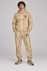AI model visualization: Beige Spanish Fly complete jacket and pants set on model, dark brown and green lines; sneakers not included
