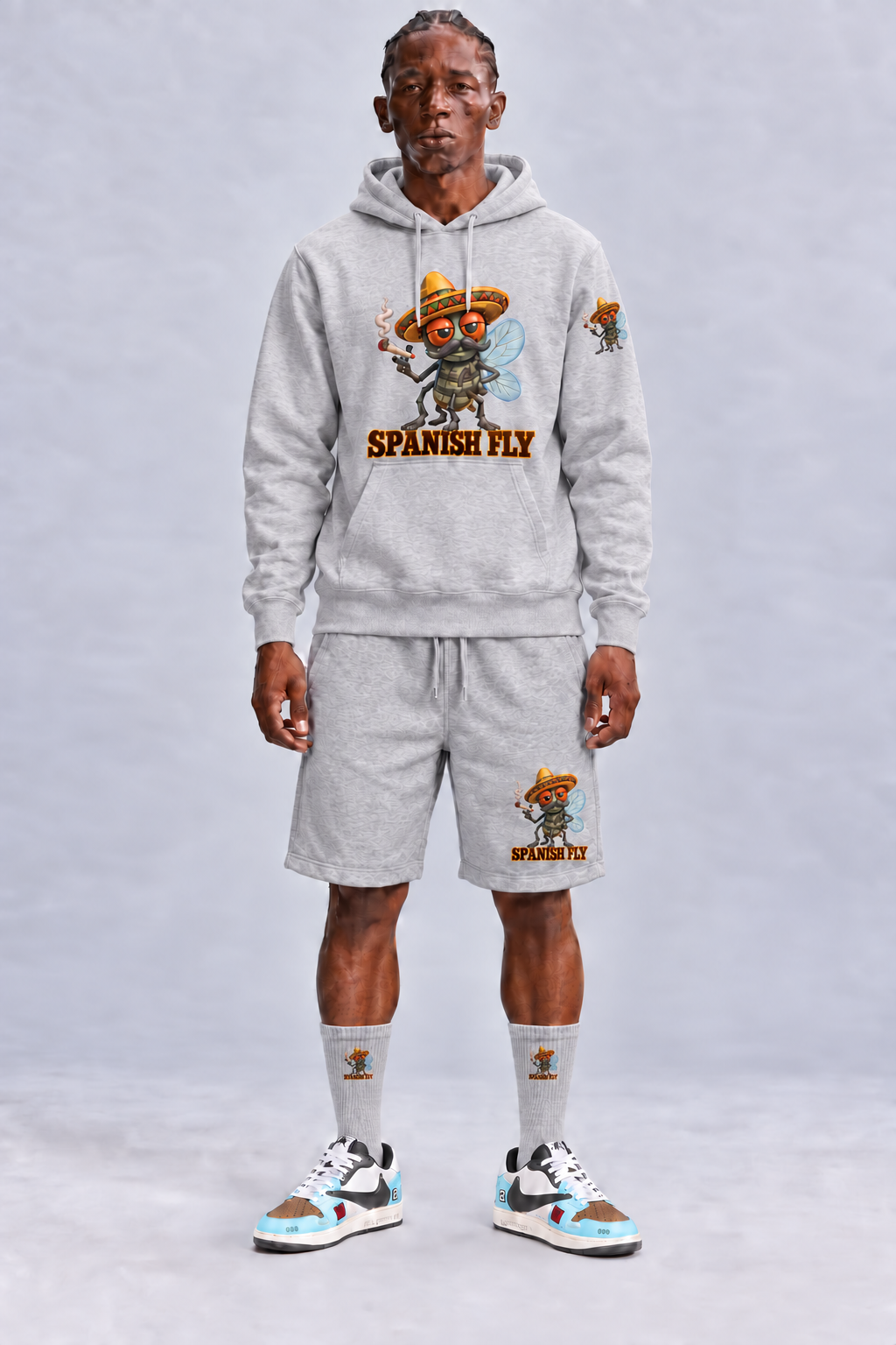 Spanish Fly hoodie Grey male model with fly-only Pepito print on left upper sleeve; styled items sold separately