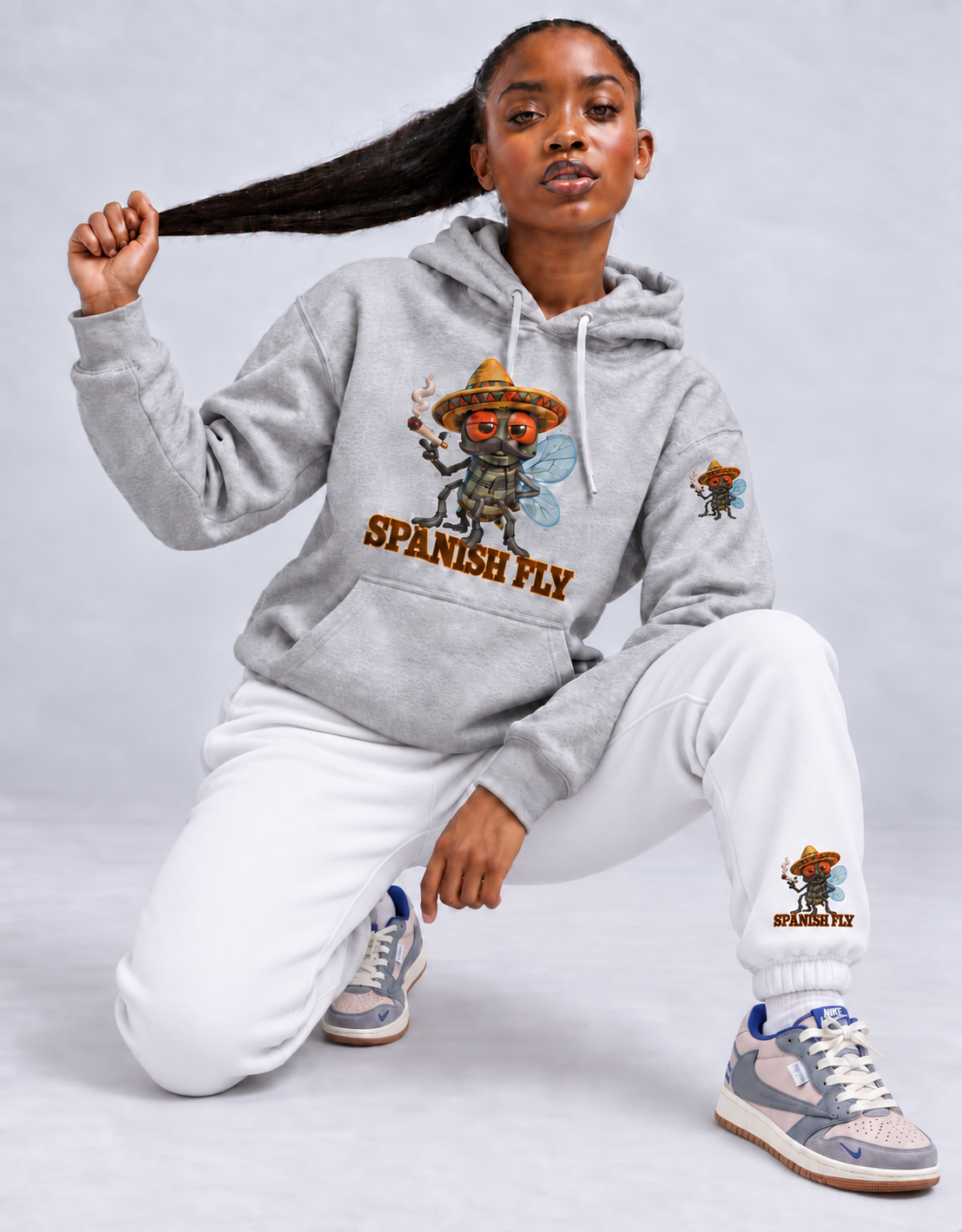 White Spanish Fly fleece joggers styled with gray hoodie with fly-only Pepito left-sleeve print; items sold separately